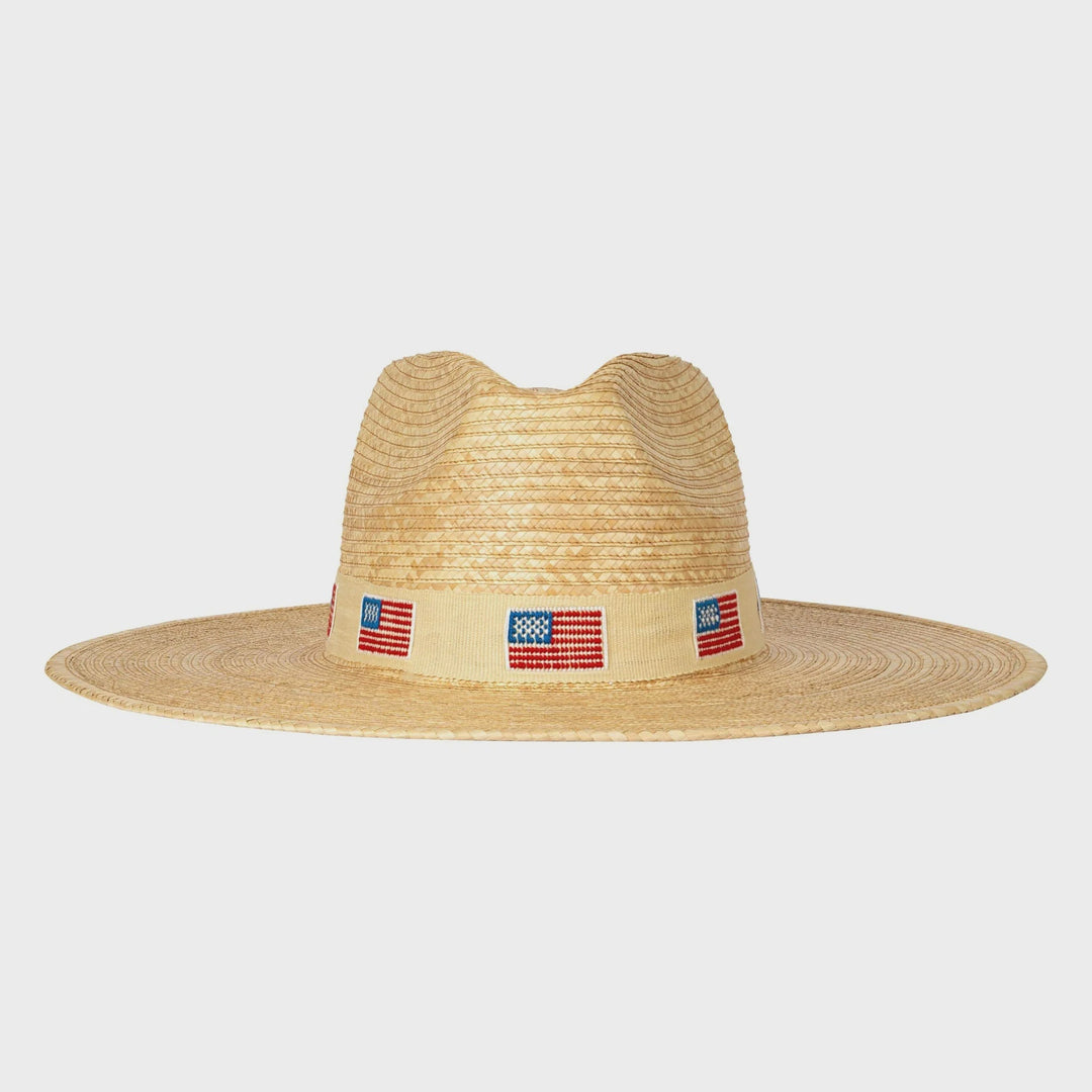 The Zertz AMERICA PALM HAT features a wide-brimmed ivory design with a beige band and small American flags, delivering sustainable style and reliable UPF protection.