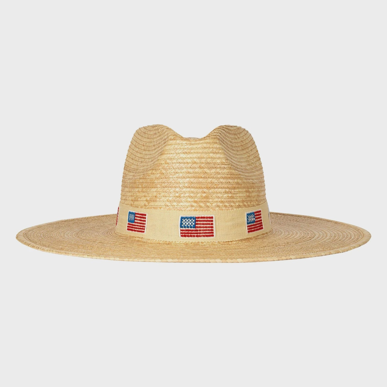 The Zertz AMERICA PALM HAT features a wide-brimmed ivory design with a beige band and small American flags, delivering sustainable style and reliable UPF protection.