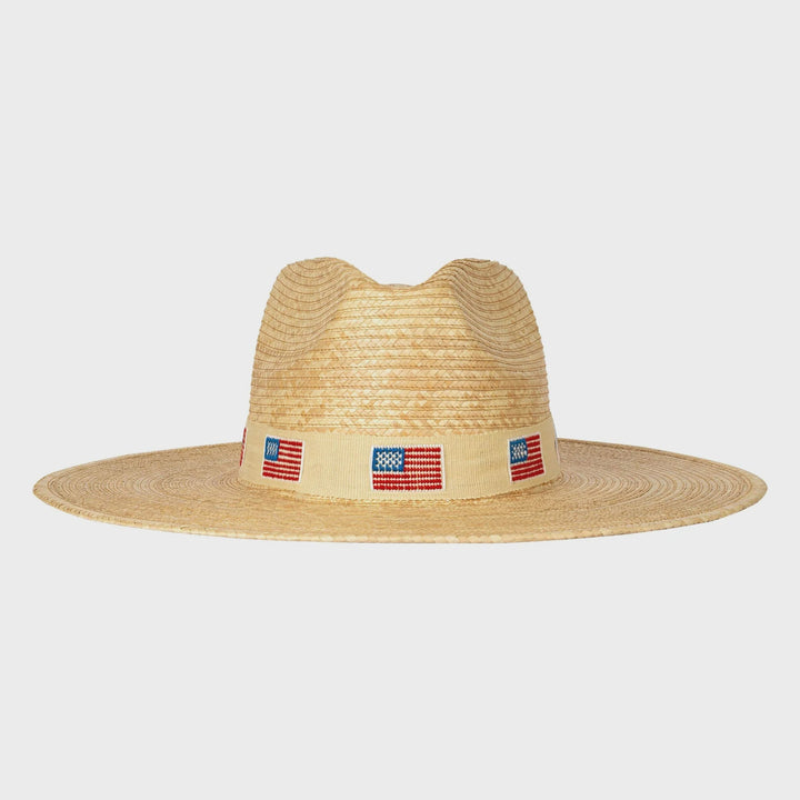 The Zertz AMERICA PALM HAT features a wide-brimmed ivory design with a beige band and small American flags, delivering sustainable style and reliable UPF protection.