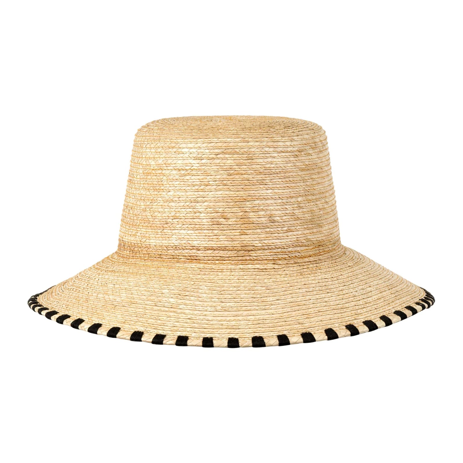 The JAKELINE BUCKET HAT by Zertz is a fair trade, natural straw hat with a wide brim, flat crown, and black stitching detail around the brim.