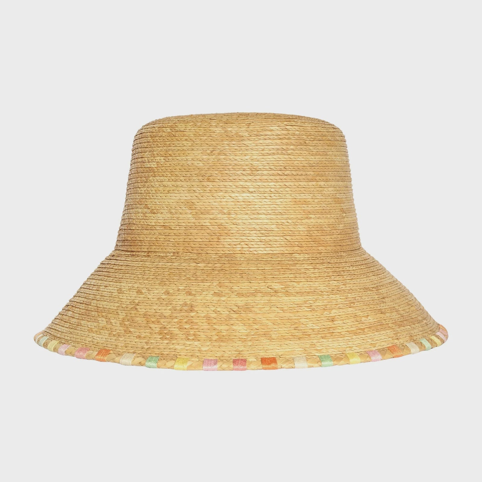 The Zertz MILA BUCKET HAT features a wide, natural straw brim with multicolored pastel squares along the edge, a flat crown, sustainable design, and UPF 50+ protection for stylish sun safety.