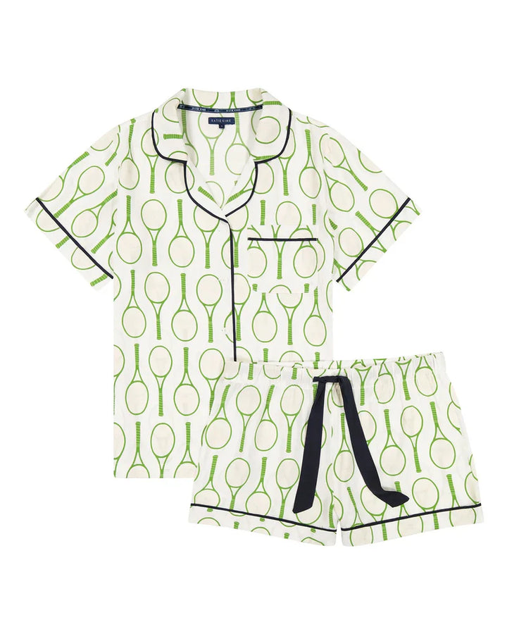 The Zertz TENNIS TIME PAJAMA SHORTS SET is a white women’s short-sleeve set with matching shorts, green tennis racket print inspired by an American Summer, black trim, chest pocket detail, and a black drawstring.