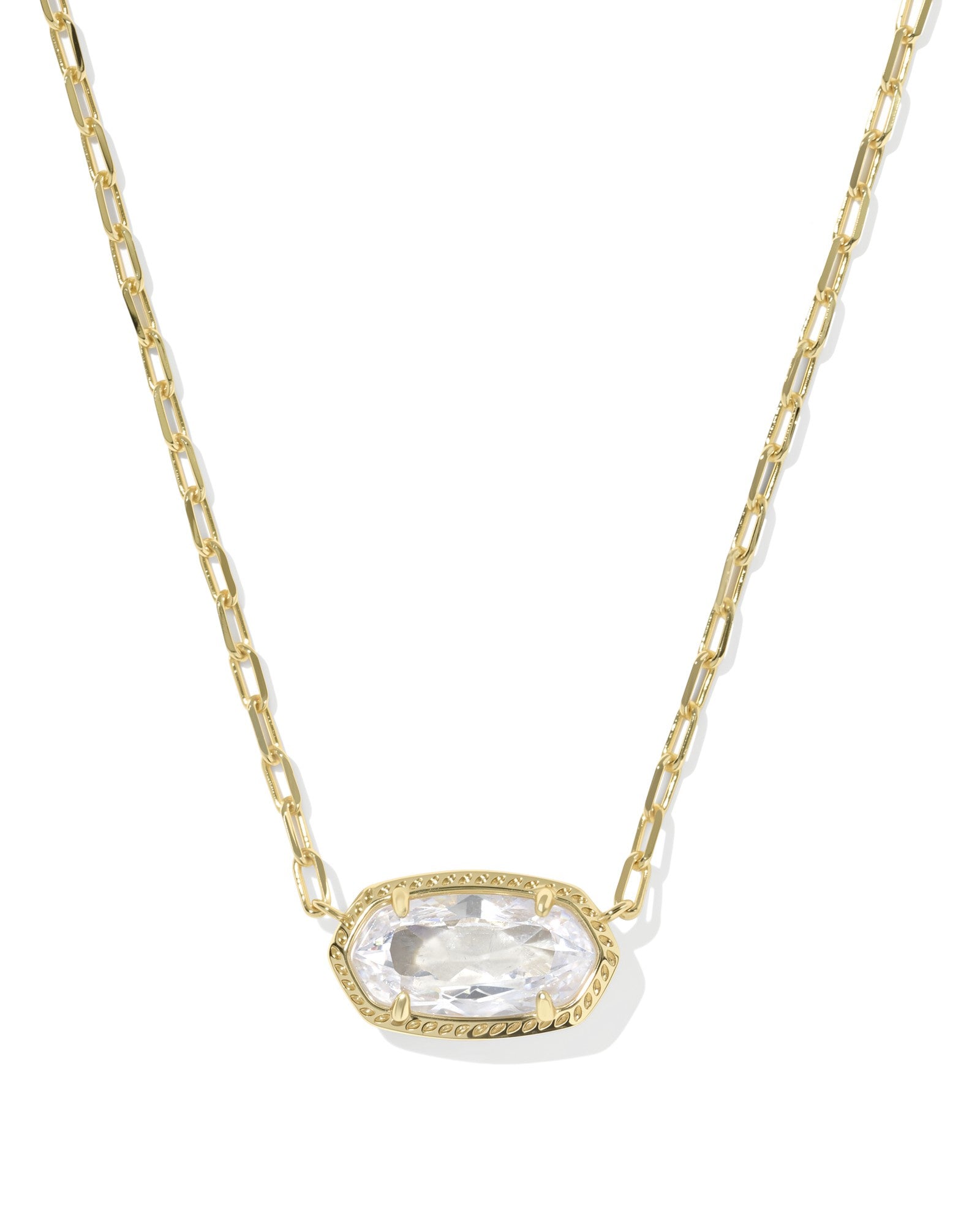 The ELISA LUXE PENDANT NECKLACE by Zertz features a gold chain and an elongated oval-shaped WHITE CZ gemstone in a decorative gold bezel, creating an effortlessly elegant jewelry piece.