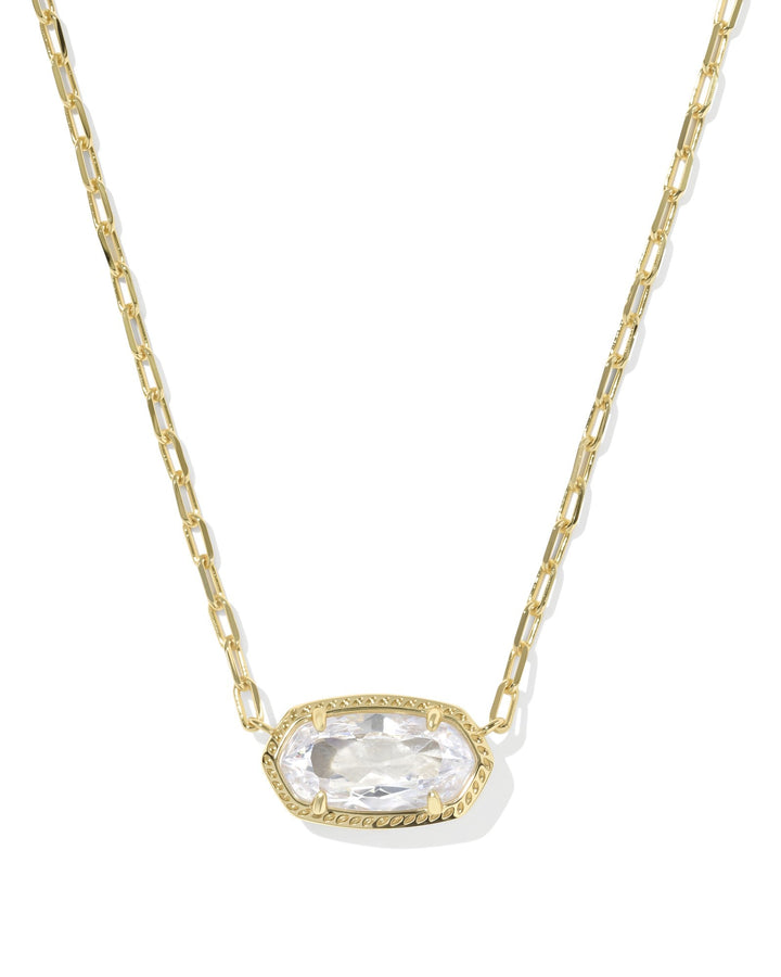 The ELISA LUXE PENDANT NECKLACE by Zertz features a gold chain and an elongated oval-shaped WHITE CZ gemstone in a decorative gold bezel, creating an effortlessly elegant jewelry piece.