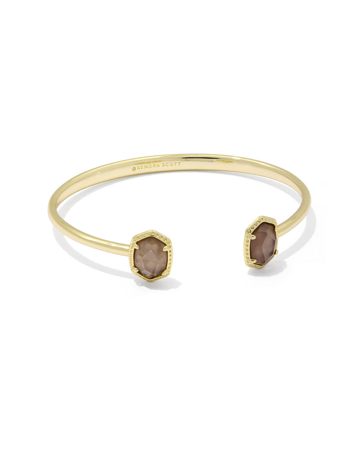 The Zertz DAPHNE FRAME CUFF BRACELET in TAUPE MOP features two hexagonal stones at each end and a structured, minimalist design—an elegant gold accessory to elevate any look.