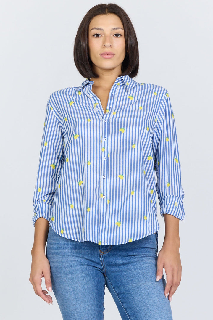 A person wearing the Zertz LOLITA TOP—a blue and white vertically striped button-up with yellow accents—and blue jeans stands facing forward against a plain light background.