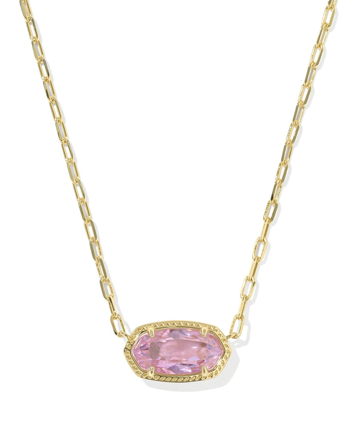 The Zertz ELISA LUXE PENDANT NECKLACE showcases a gold chain with an elongated oval LT PINK CZ gemstone pendant framed by a decorative gold border—an elegant jewelry piece displayed on a white background.