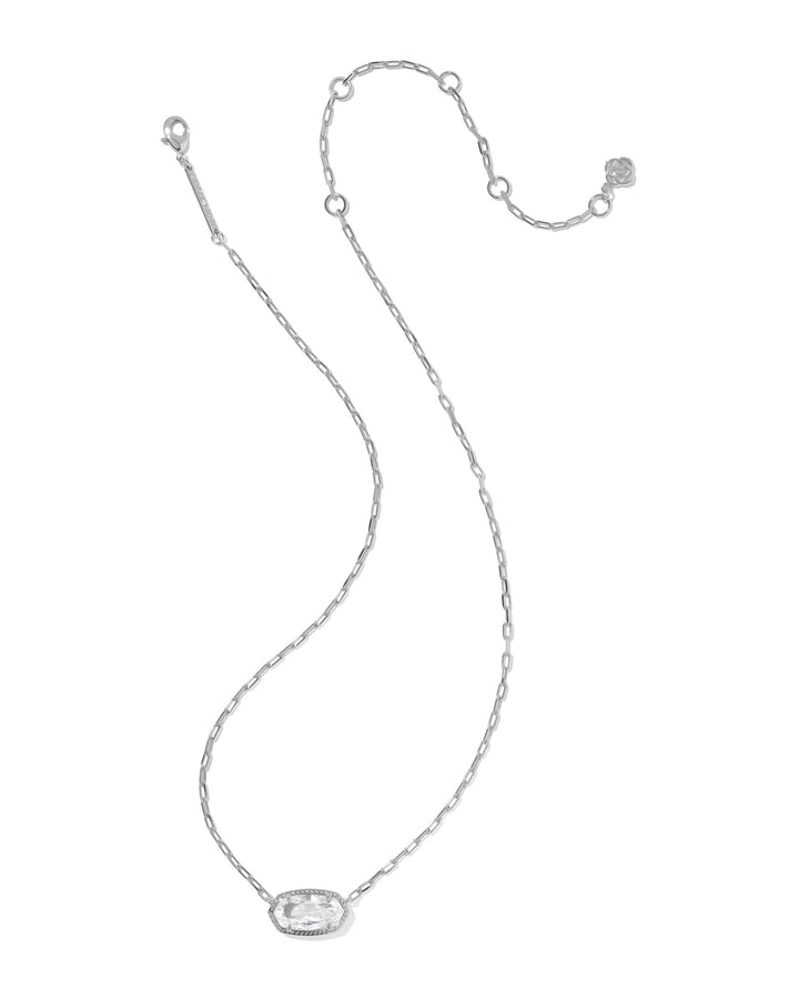 The ELISA LUXE PENDANT NECKLACE by Zertz features a silver chain with an oval-shaped pendant, clear faceted gemstone, sparkling accents, and an adjustable clasp for the perfect fit.