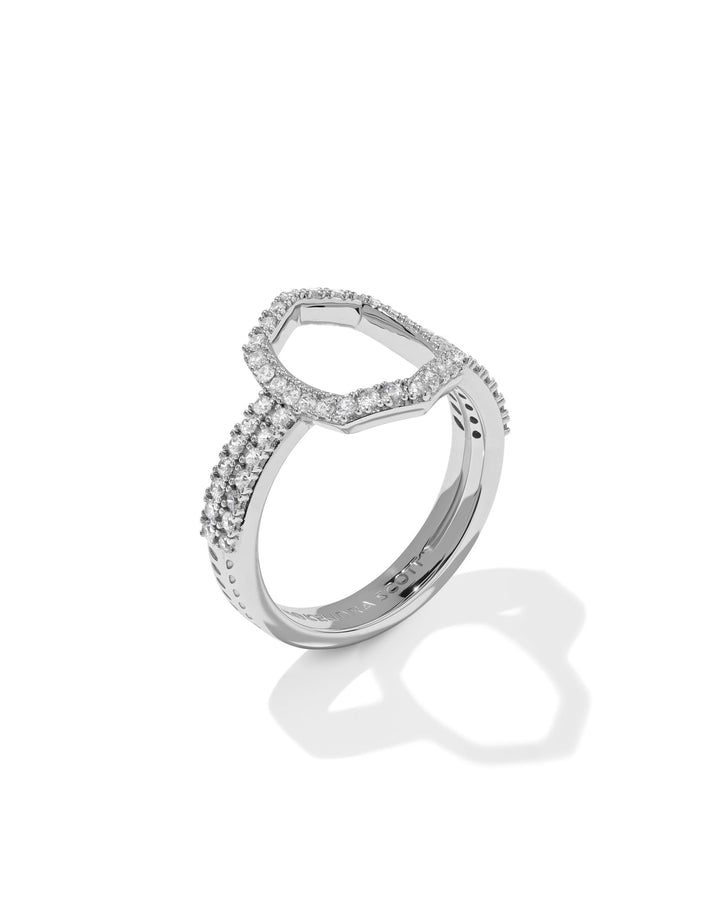 The Zertz DAPHNE PAVE COCKTAIL RING is a silver ring with two pavé-adorned bands and a diamond-encrusted geometric outline, creating a striking statement piece against a white background.