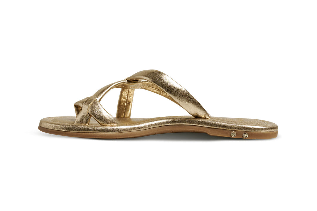 The Zertz SUNGEM SANDAL features gold metallic crisscross straps and a slight heel, shown in a side view against a white background—ideal for stylish summer wear.