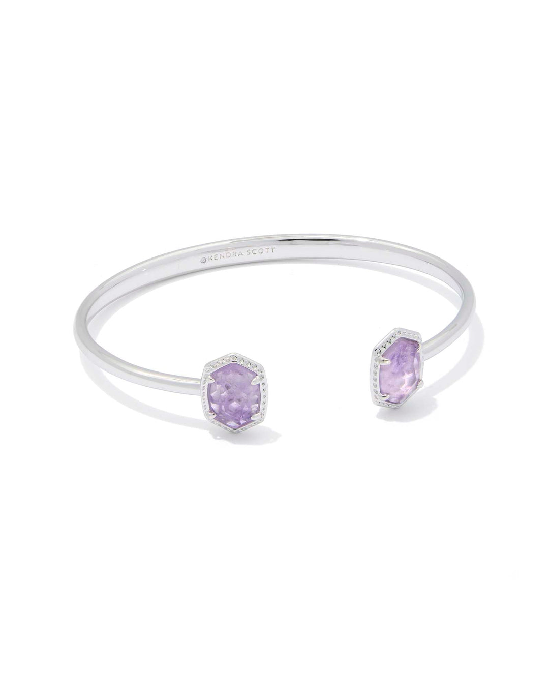 The DAPHNE FRAME CUFF BRACELET by Zertz features two purple amethyst gemstones set in a structured silver open cuff, offering an elegant accessory perfect for any occasion.
