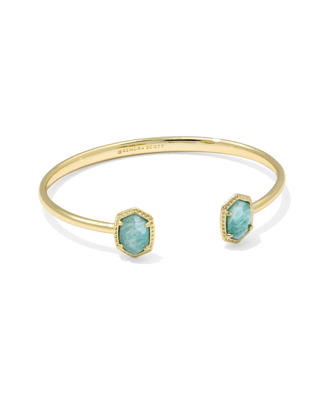 The Zertz DAPHNE FRAME CUFF BRACELET features teal amazonite hexagonal stones on each end of a gold open cuff, accented with delicate edge detailing for an elegant touch.