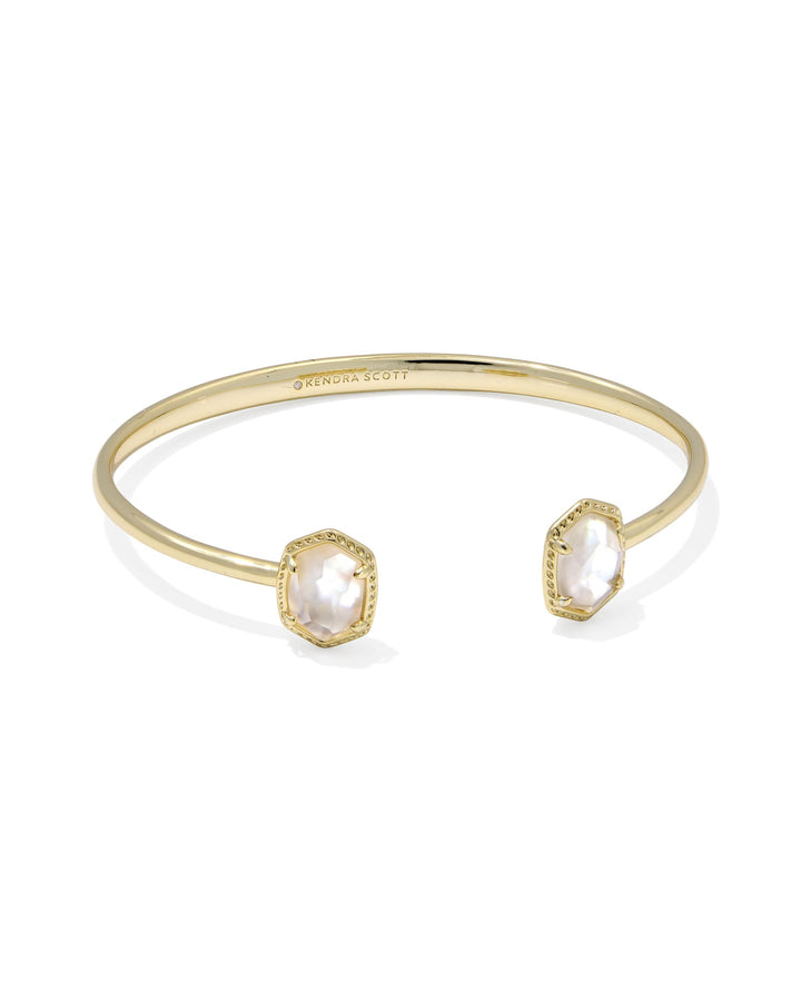 The Zertz DAPHNE FRAME CUFF BRACELET features a structured open-frame design in IVORY MOP, accented with two hexagonal white stones. This elegant yet minimal accessory adds refined style to your wrist.