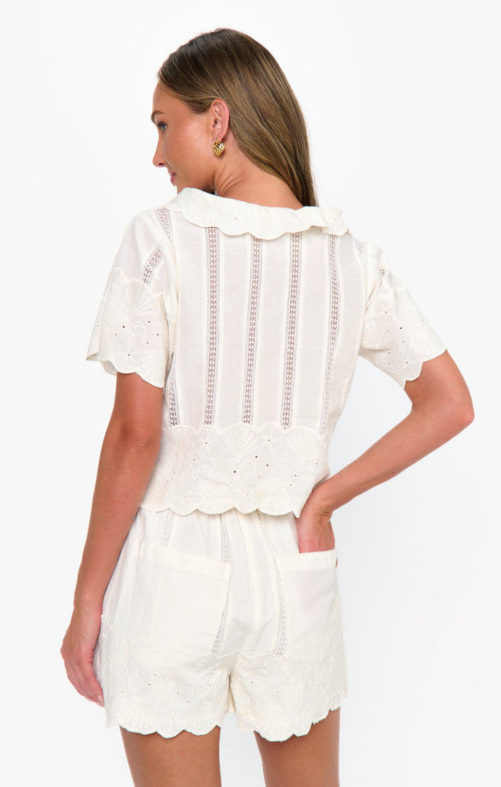 A woman stands with her back to the camera, wearing Zertz&